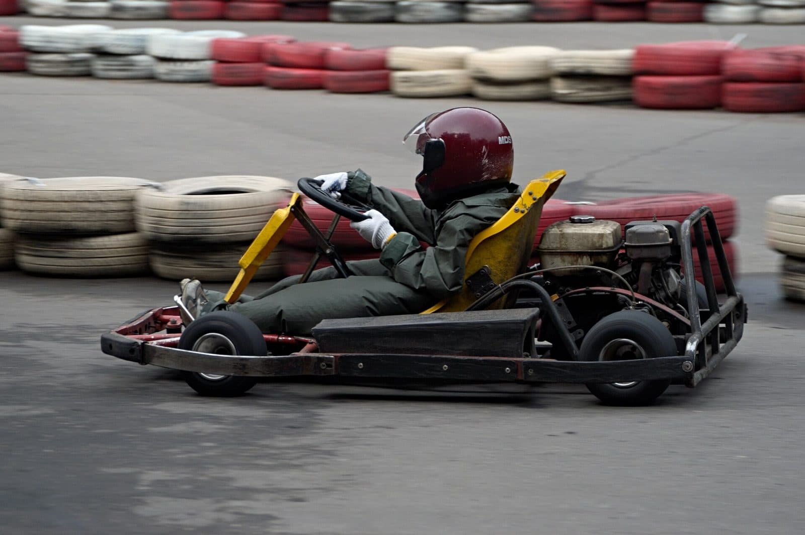 A young driver in a kart at the track