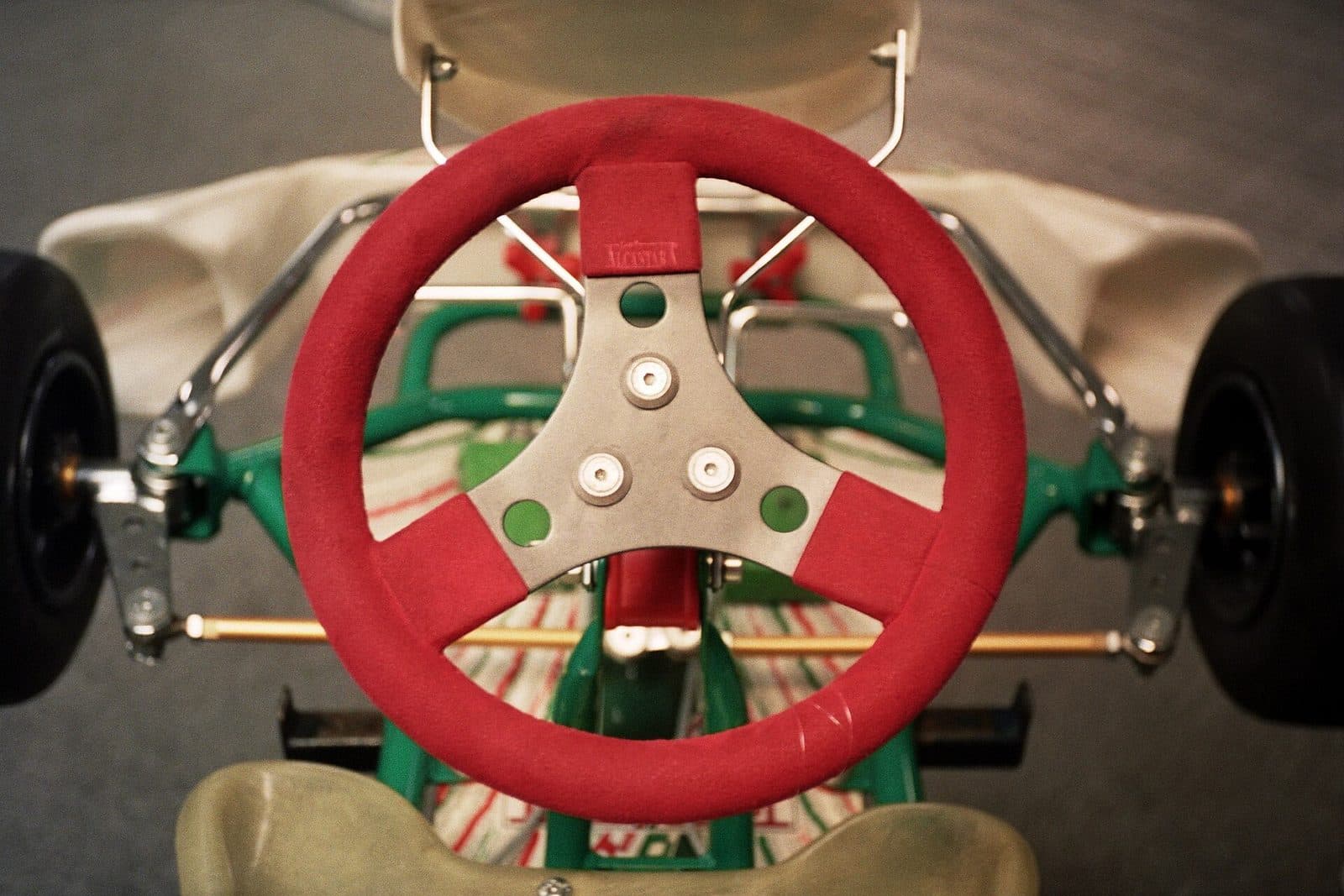 A driver's view over the steering wheel of a racing kart