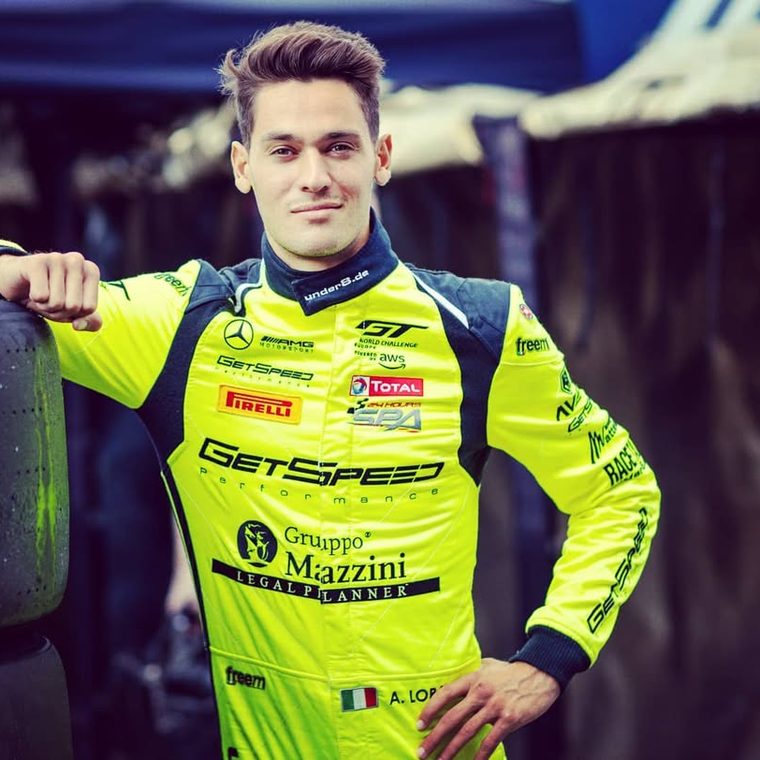 Alessio Lorandi, Founder of PURPL, in his race suit in the paddock